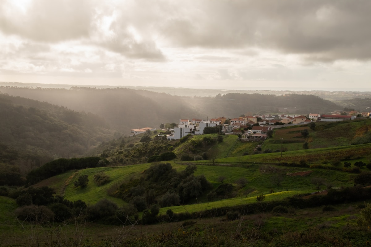 A village nestled in rolling green hills, characteristic of Portugal&rsquo;s interior highlands. Photo by Filipe Nobre on Unsplash